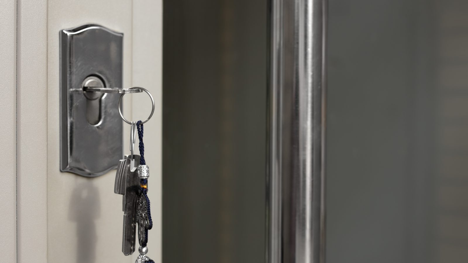 A bunch of keys left hanging in the cylinder of an apartment door