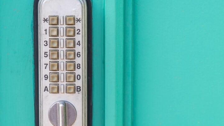 A mechanical pushbutton keyless entry lock mounted on a painted exterior door